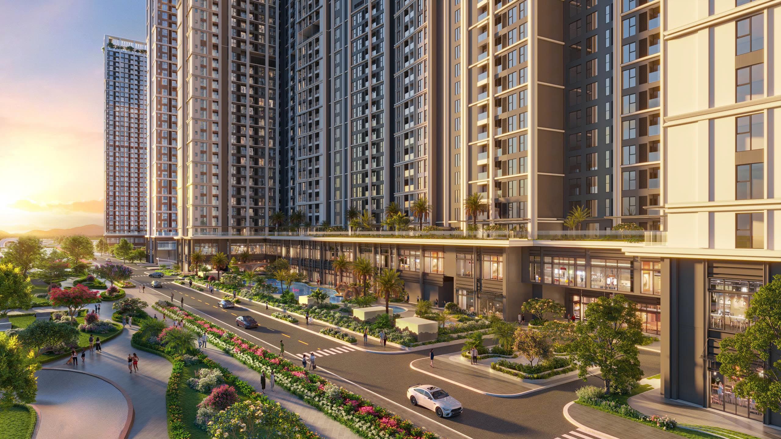 Cụm tháp căn hộ với khối đế thương mại, đại lộ nhiều làn và dải hoa cảnh lúc chiều tà