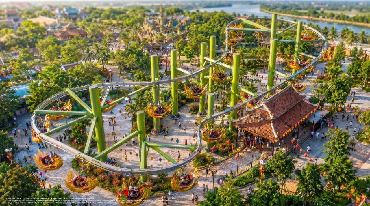 Phối cảnh từ trên cao đường ray tàu lượn siêu tốc màu xanh uốn lượn giữa các công trình mái ngói của công viên